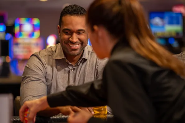 Man smiling while playing blackjack