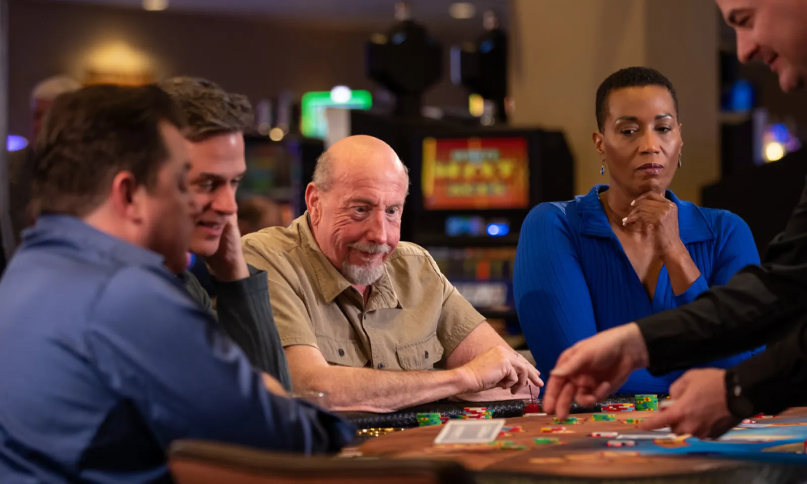 three men and a woman playing poker at Little River Casino