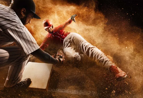 Baseball player sliding to base 