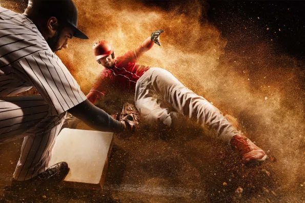 Baseball player sliding to base