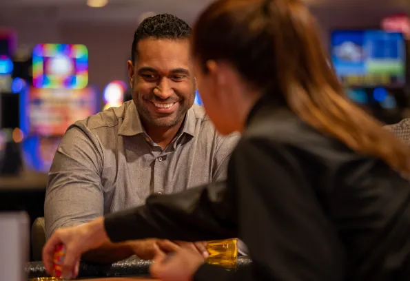 Man smiling while playing blackjack