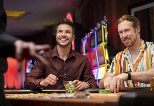 Two young guys playing blackjack at Little River Casino Resort