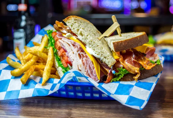 Sandwich and fries in a blue basket 