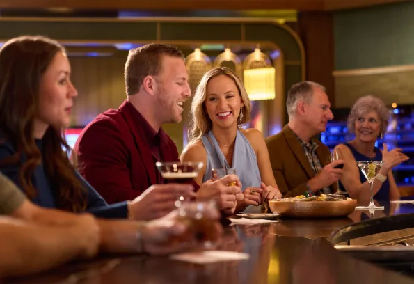 Guests enjoying cocktails and conversation at the upscale bar inside Heron restaurant at Little River Casino Resort in Manistee, Michigan.