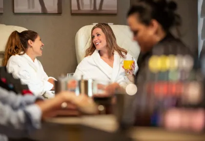 Guests enjoying manicures and refreshments in the spa lounge at Little River Casino Resort in Manistee, Michigan