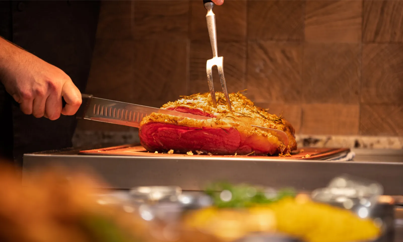 Man slicing a cooked prime rib at Big Lake Buffet at Little River Casino Resort