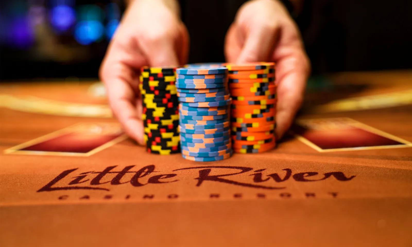Neatly stacked poker chips above a Little River logo