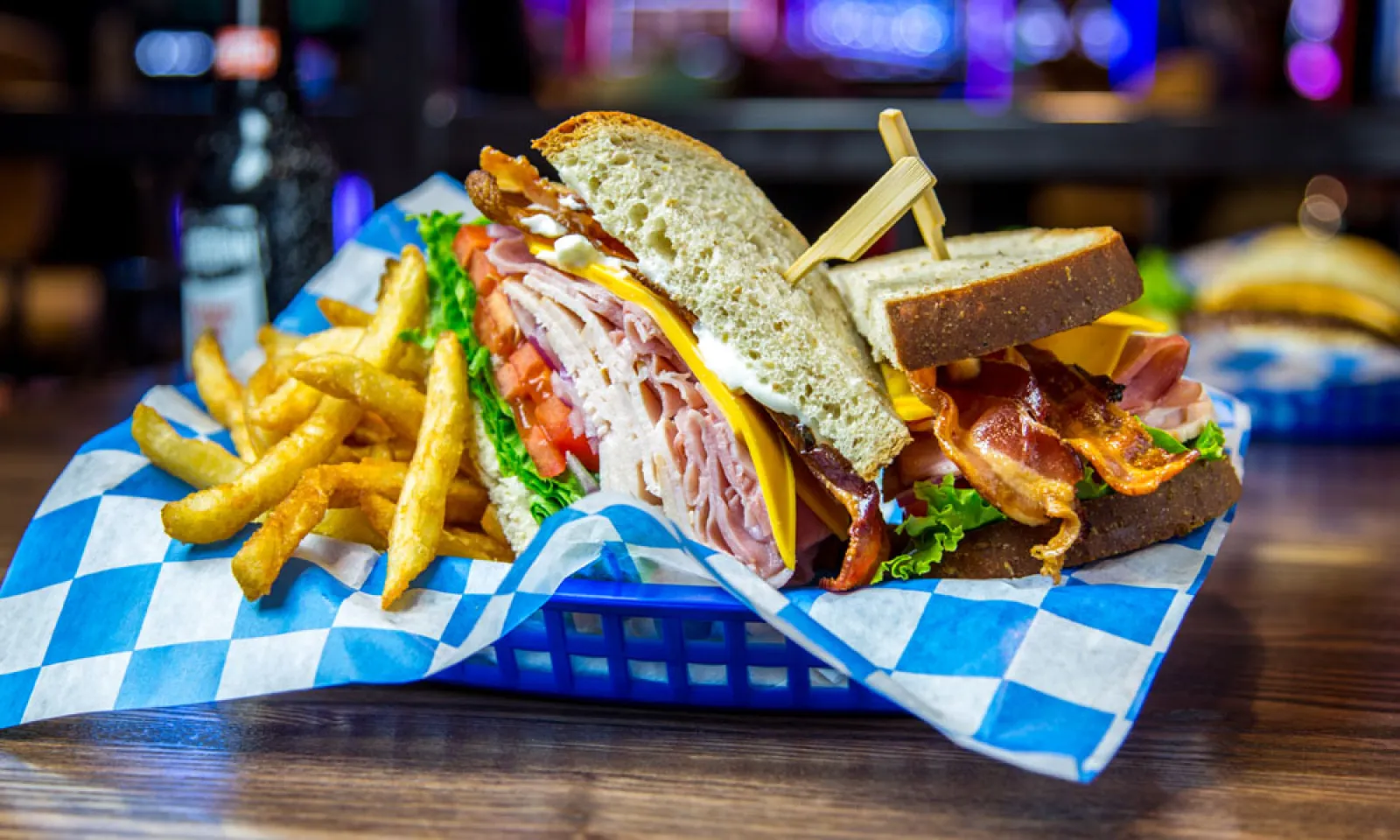 Sandwich and fries in a blue basket