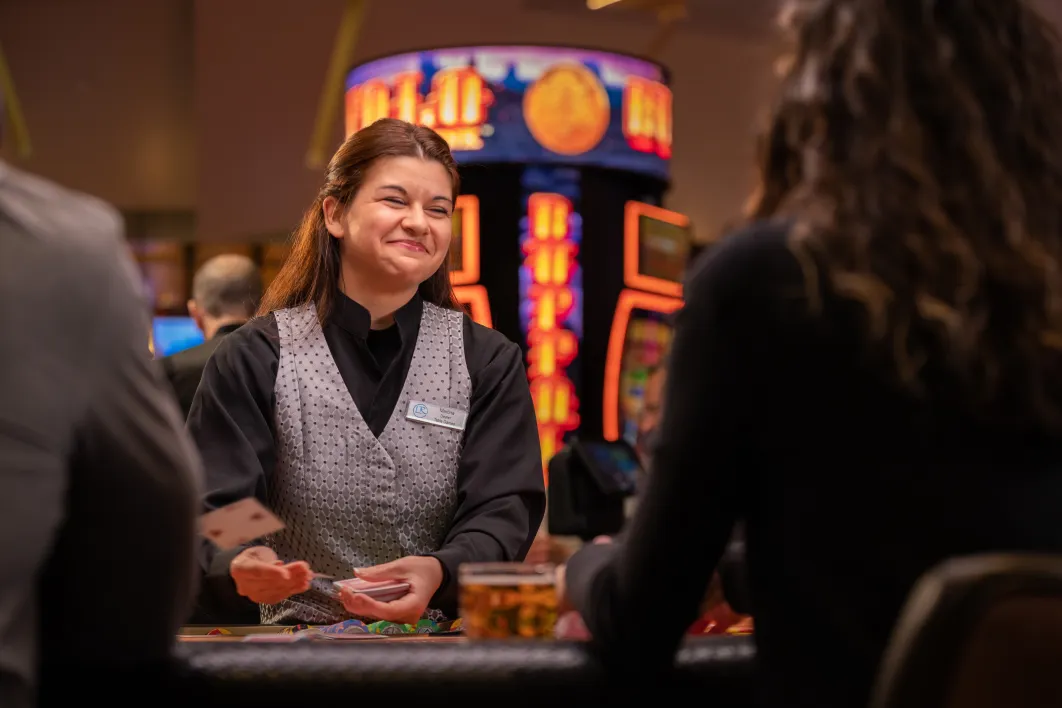 Little River Casino Resort Table Games Dealer Smiling while dealing cards