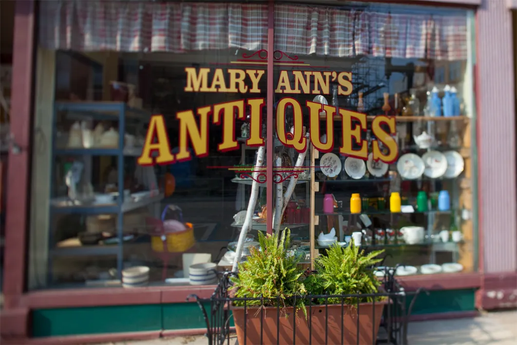 Storefront window to MaryAnn's Antiques shop in Manistee Michigan