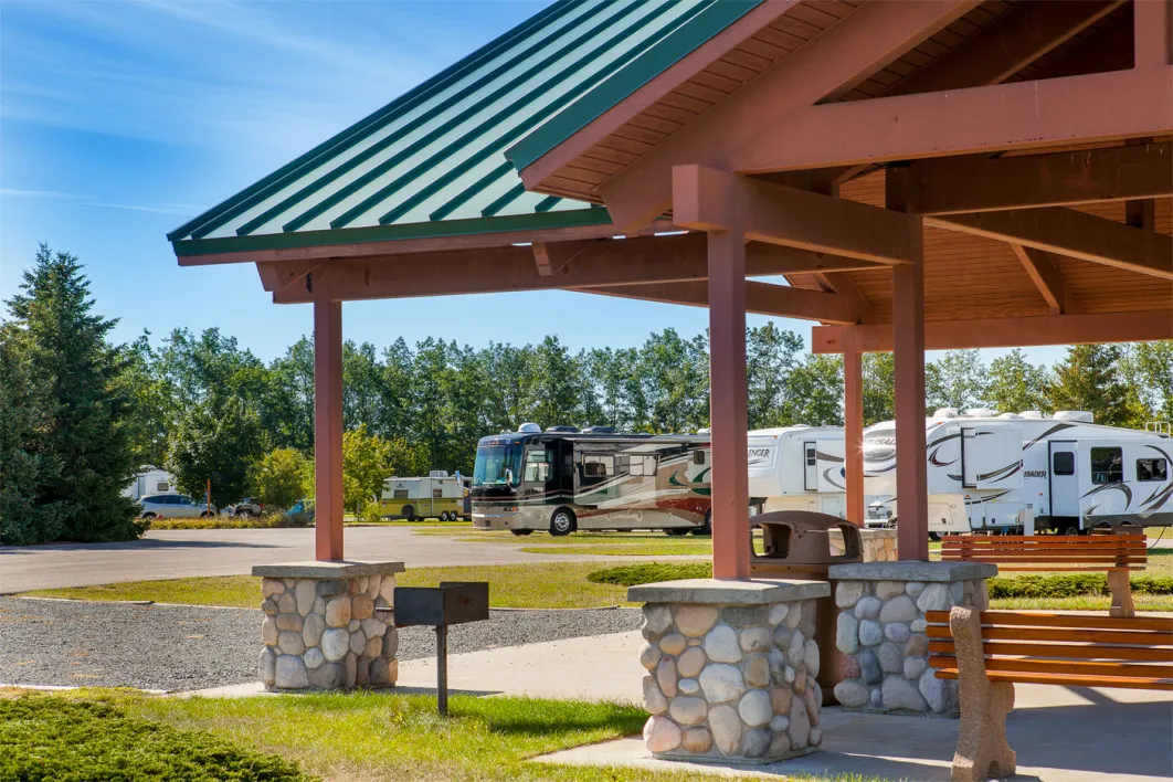 Wooden pavilion with RV trailers pictured in the background